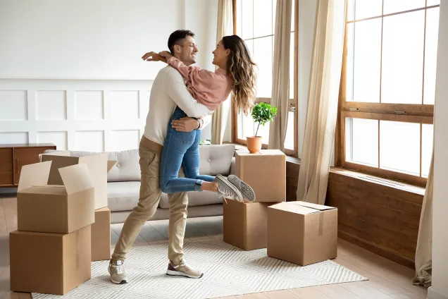 happy young couple moving into new house 